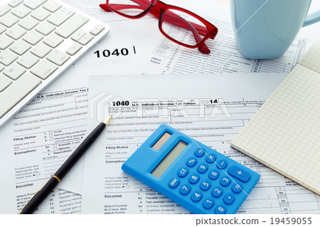 Tax return form with pen and calculator 19459055