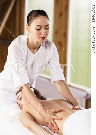 Beautiful brunette enjoying a massage Beautiful brunette enjoying a massage 19462598