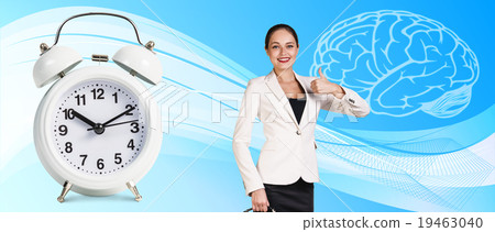 Business woman near classical alarm clock  19463040