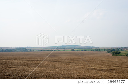 Fields with village and blue sky Fields with village and blue sky 19467377