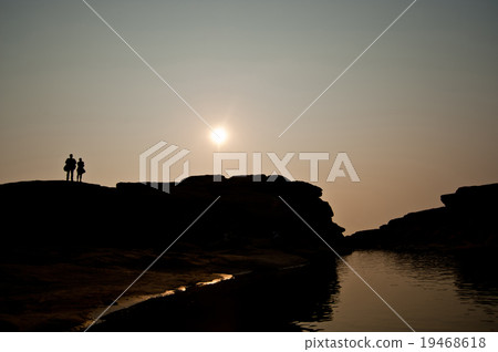 Photographer silhouette sunset at rock holes Stone Photographer silhouette sunset at rock holes Stone 19468618