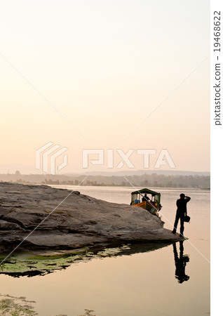 Photographer silhouette sunset at rock holes Stone 19468622