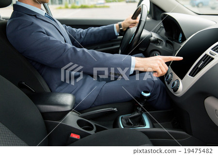 close up of young man in suit driving car close up of young man in suit driving car 19475482