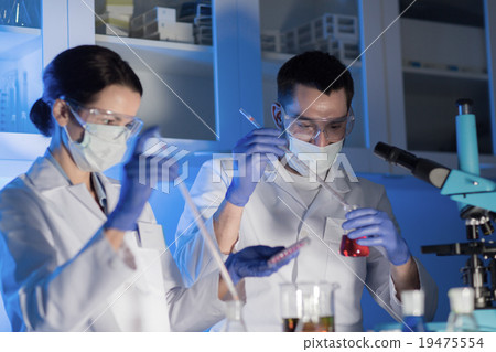 close up of scientists making test in lab 19475554