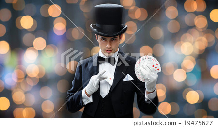 magician showing trick with playing cards magician showing trick with playing cards 19475627