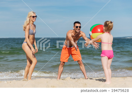 happy family playing with inflatable ball on beach happy family playing with inflatable ball on beach 19475628