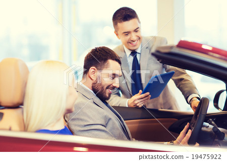 happy couple with car dealer in auto show or salon happy couple with car dealer in auto show or salon 19475922