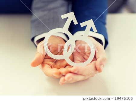 close up of happy male gay couple with love symbol 19476166