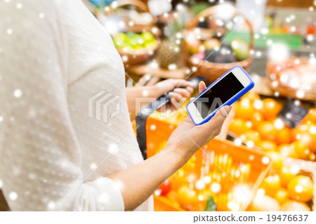 close up of woman with food basket in market 19476637
