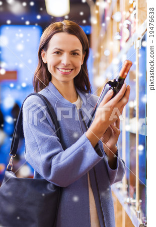 happy woman choosing and buying wine in market happy woman choosing and buying wine in market 19476638