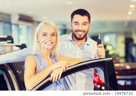 happy couple buying car in auto show or salon happy couple buying car in auto show or salon 19476710
