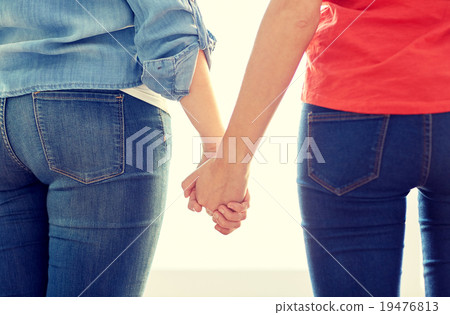 close up of lesbian couple holding hands 19476813