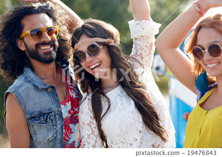 happy young hippie friends dancing outdoors 19476843