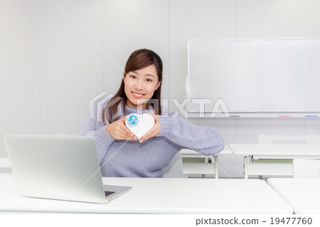 A woman with a heart-shaped gift box 19477760