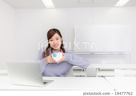 A woman with a heart-shaped gift box A woman with a heart-shaped gift box 19477762