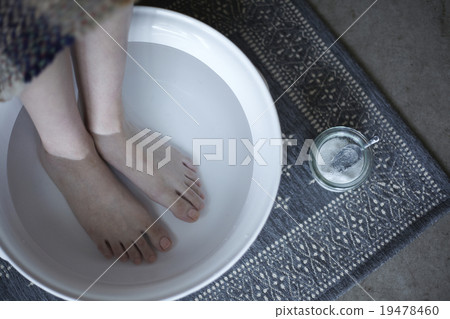 A woman enjoying a foot bath A woman enjoying a foot bath 19478460