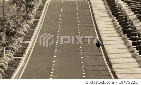 A man walking alone along the road A man walking alone along the road 19479220