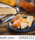 Pieces of cheese and confiture on the blue plate 19480152