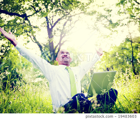 Businessman Sitting In a Forest With His Laptop Concept Businessman Sitting In a Forest With His Laptop Concept 19483603