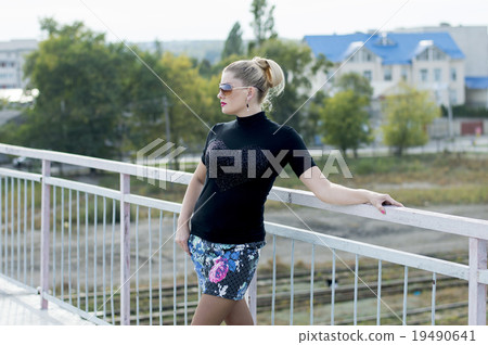 girl in a miniskirt on the bridge, railway tracks girl in a miniskirt on the bridge, railway tracks 19490641
