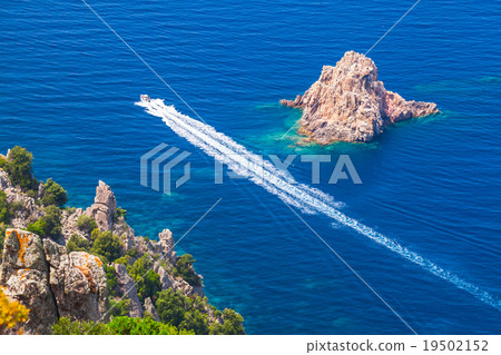 Fast motor boat goes near rocks of Capo Rosso 19502152