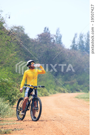young bicycle (cyclist) man drinking fresh water 19507427