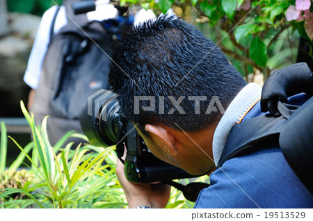 Professional photographer on outdoor duty 19513529
