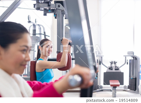 Women exercising at fitness gym Women exercising at fitness gym 19514809