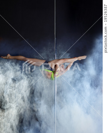 Flexible pole dancer performs acrobatic pas 19526387