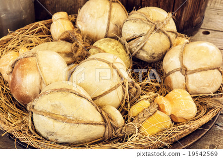 Yellow decorative pumpkins in the wicker basket Yellow decorative pumpkins in the wicker basket 19542569