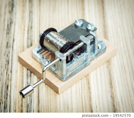 Old little music box on the wooden background Old little music box on the wooden background 19542570