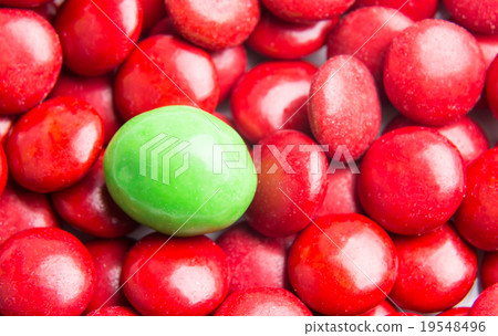 Focus on green chocolate candy against red Focus on green chocolate candy against red 19548496