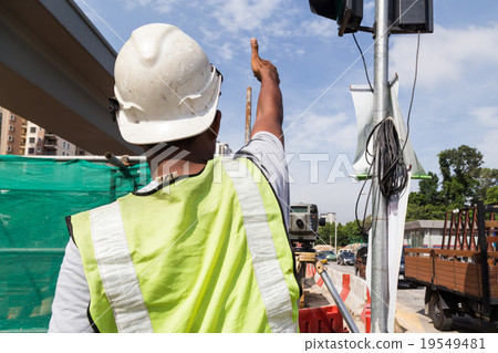 Surveyor gesturing after taking readings Surveyor gesturing after taking readings 19549481