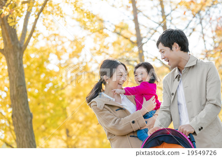 Three people walking in autumn park 19549726