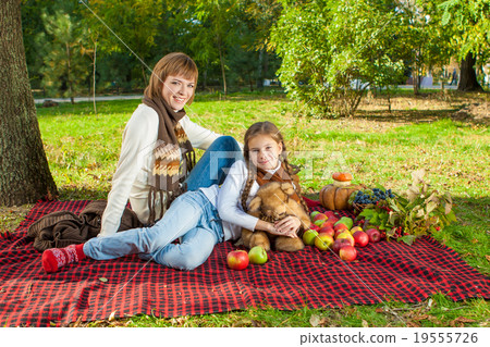 Happy mother with little daughter in autumn park Happy mother with little daughter in autumn park 19555726