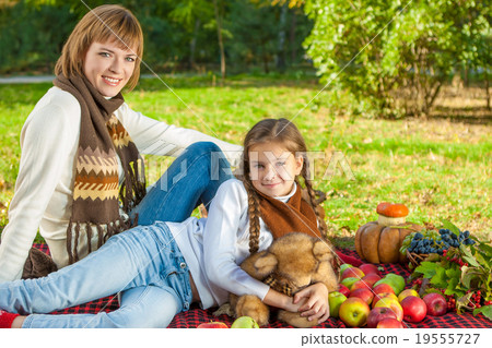 Happy mother with little daughter in autumn park Happy mother with little daughter in autumn park 19555727