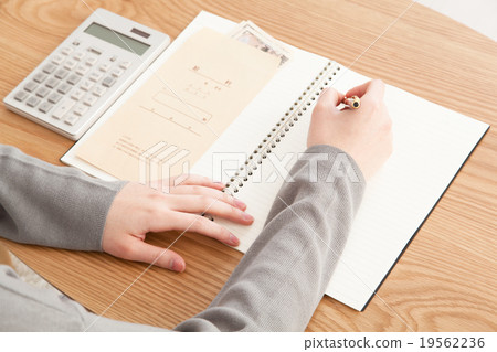 Housewife putting household account book image 19562236