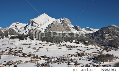 Snow covered Mt Säntis and village Wildhaus 19568163