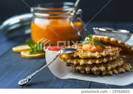 Wafers with drop of jam and silver spoon on paper Wafers with drop of jam and silver spoon on paper 19568605