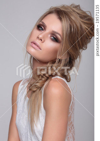 Woman sitting on white background. 19571135
