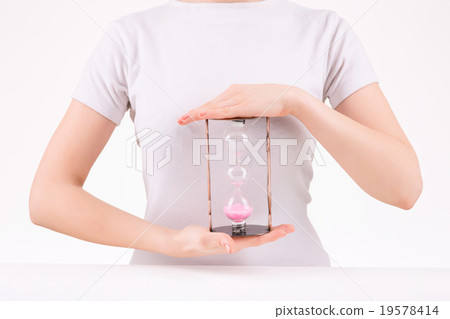 Woman holding three-leveled hourglass. Woman holding three-leveled hourglass. 19578414