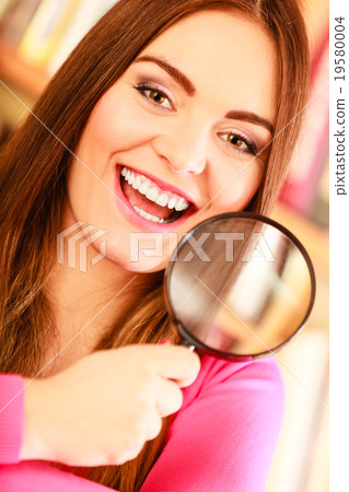 Girl holding magnifying glass Girl holding magnifying glass 19580004