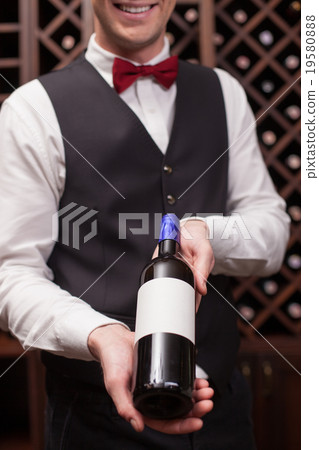 Cheerful young sommelier is working in cellar 19580888