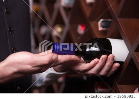 Experienced male worker is choosing drink in Experienced male worker is choosing drink in 19580923