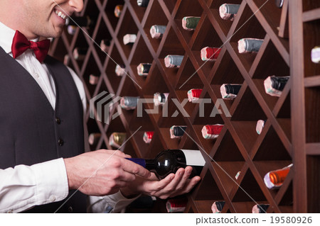 Skillful waiter is working in a restaurant Skillful waiter is working in a restaurant 19580926
