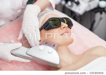 Attractive woman is caring of skin at spa 19580948