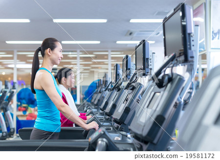 Women exercising at fitness gym Women exercising at fitness gym 19581172