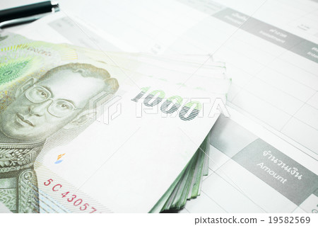 Thai money banknote on record table note book Thai money banknote on record table note book 19582569
