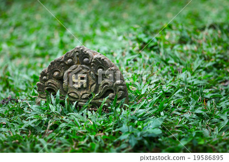 Tombstone with image of ancient symbol - swastika 19586895