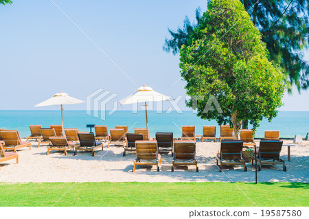 Umbrella pool and chair on the beach Umbrella pool and chair on the beach 19587580